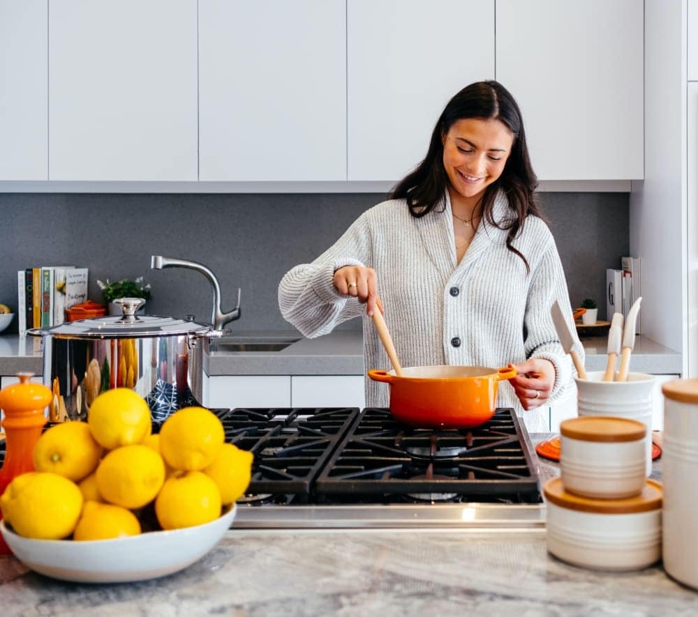 woman cooking in her kitchen woman cooking in her kitchen